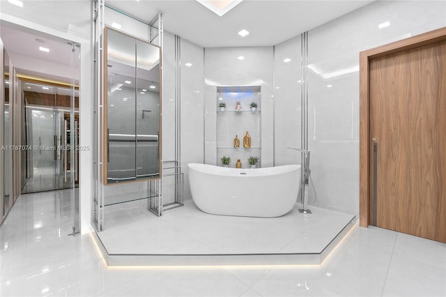 bathroom featuring a freestanding bath and tile patterned floors