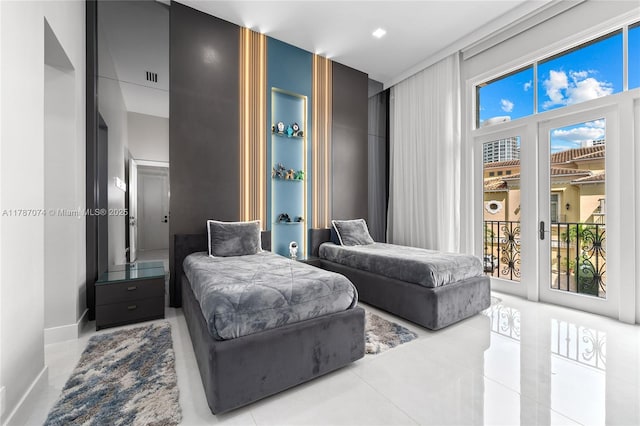 bedroom featuring tile patterned floors, baseboards, and access to exterior