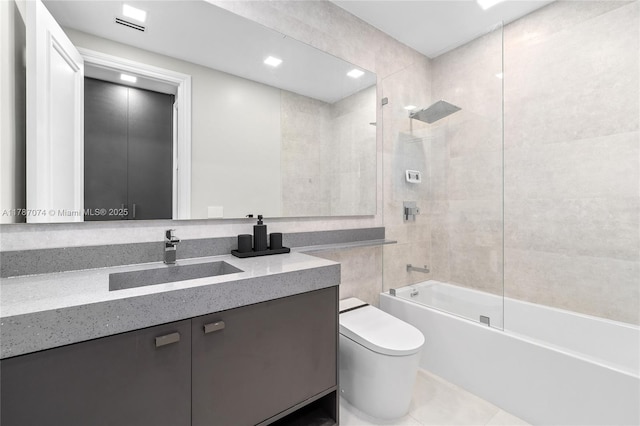 bathroom featuring tile patterned flooring, toilet, shower / washtub combination, and vanity