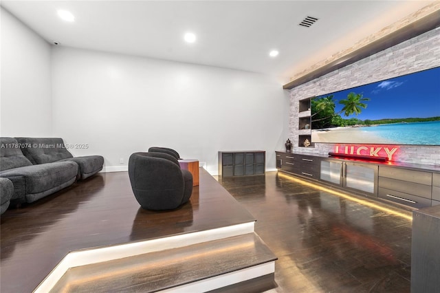 living room featuring baseboards, visible vents, built in features, and recessed lighting