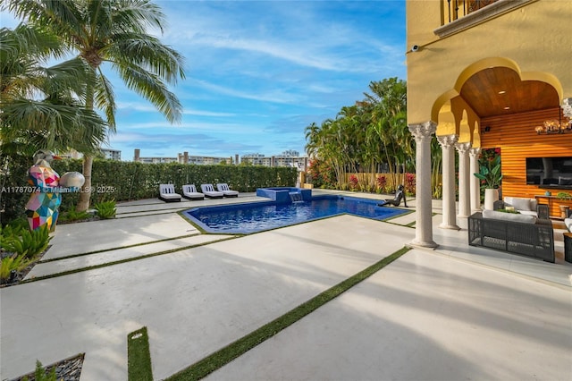 view of swimming pool featuring a patio, outdoor lounge area, a fenced in pool, and a fenced backyard