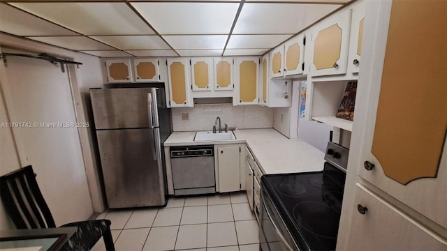 1801 S Ocean Dr Unit 842, Hallandale Beach, FL 33009 - kitchen featuring appliances with stainless steel finishes, a sink, light countertops, light tile patterned floors, and glass insert cabinets