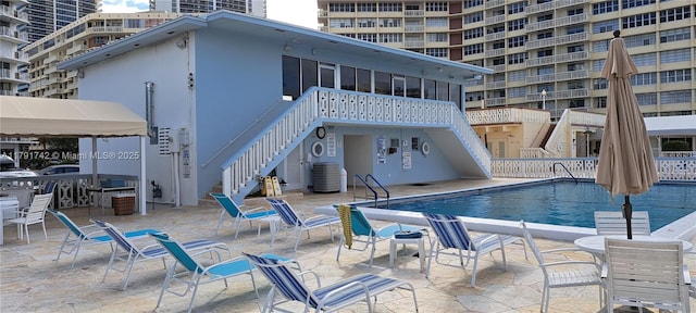 1801 S Ocean Dr Unit 842, Hallandale Beach, FL 33009 - community pool featuring a sunroom, central AC unit, stairs, and a patio area