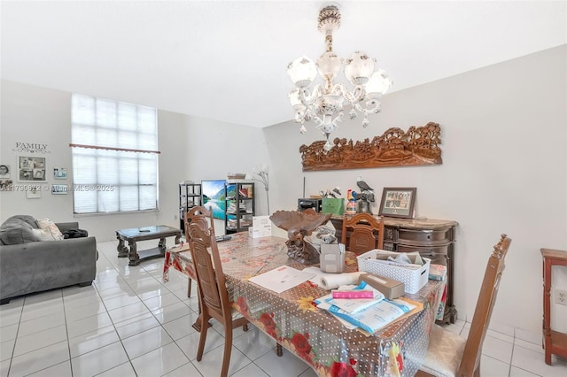 dining space with light tile patterned floors and a notable chandelier