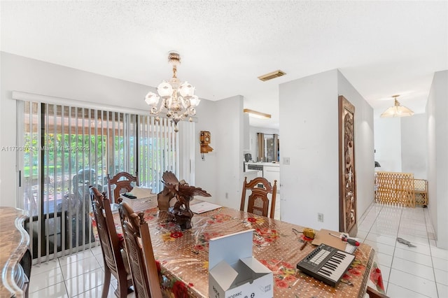 dining room with visible vents, light tile patterned floors, and an inviting chandelier