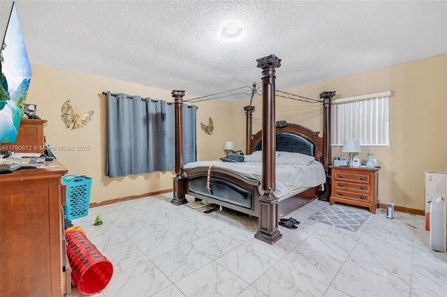 bedroom featuring a textured ceiling, marble finish floor, and baseboards