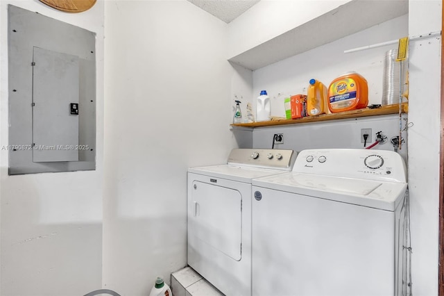 washroom featuring washer and dryer, electric panel, and laundry area