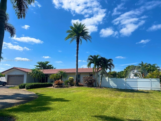 14051 SW 15th Ct, Davie, FL 33325 - view of front of house featuring a tiled roof, an attached garage, stucco siding, and driveway