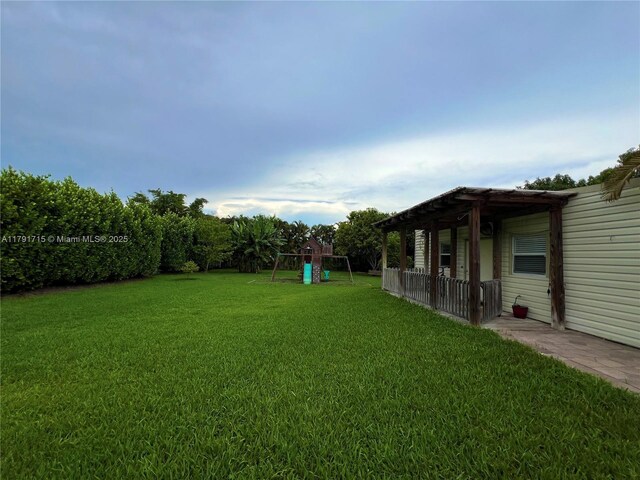 14051 SW 15th Ct, Davie, FL 33325 - view of grassy yard featuring a playground and a pergola