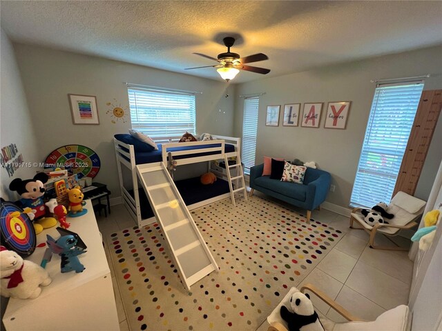 14051 SW 15th Ct, Davie, FL 33325 - bedroom featuring light tile patterned floors, ceiling fan, a textured ceiling, and baseboards