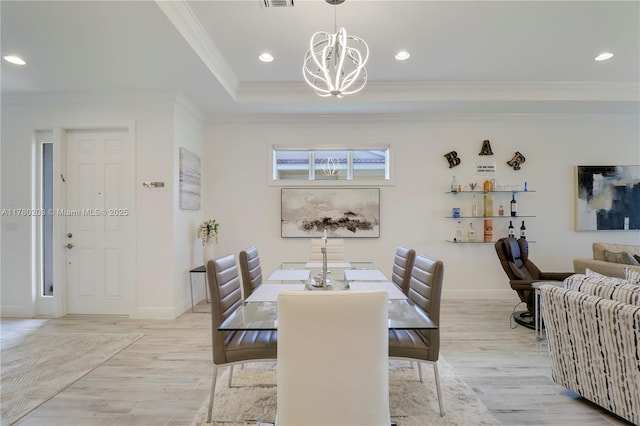 26047 SW Viterbo Way, Port St Lucie, FL 34986 - dining room featuring light wood finished floors, ornamental molding, a notable chandelier, and baseboards