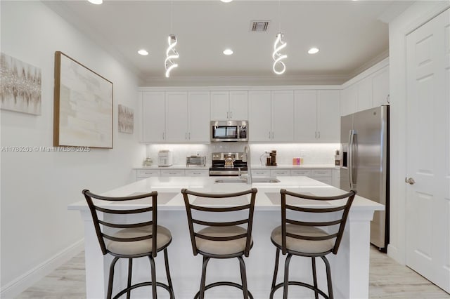 26047 SW Viterbo Way, Port St Lucie, FL 34986 - kitchen with backsplash, appliances with stainless steel finishes, light countertops, and a sink