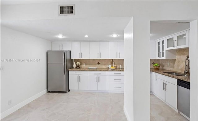 8091 NW 12th St Unit H, Margate, FL 33063 - kitchen featuring stainless steel appliances, a sink, dark stone counters, tasteful backsplash, and recessed lighting