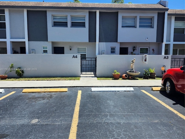 exterior space featuring fence private yard and uncovered parking