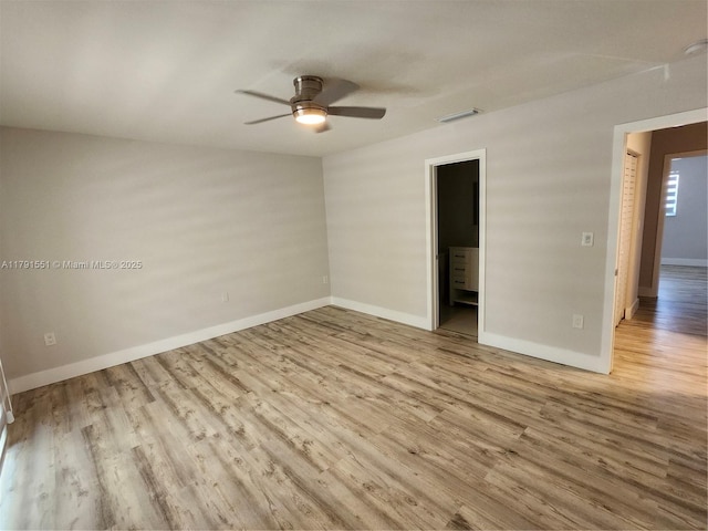 unfurnished bedroom featuring baseboards, visible vents, wood finished floors, and ceiling fan