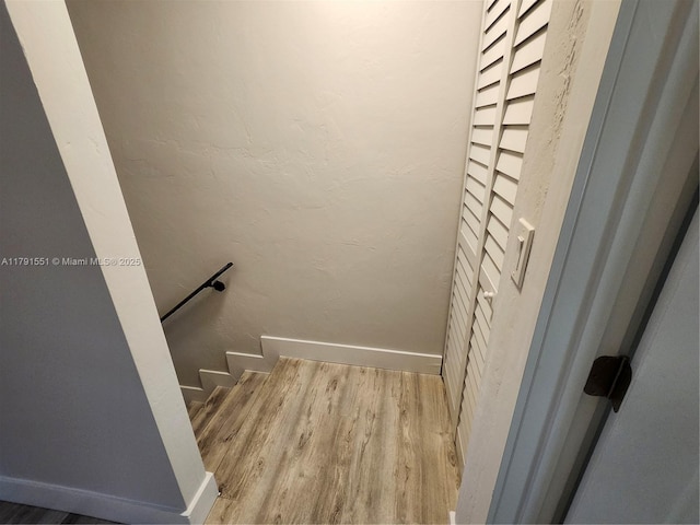 stairs with baseboards and wood finished floors