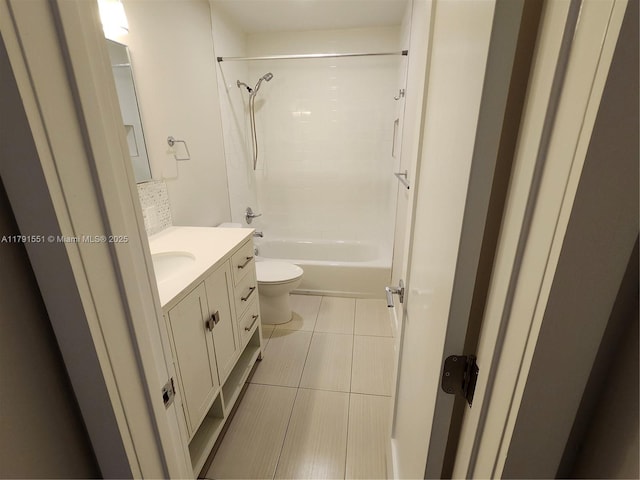 bathroom featuring tile patterned floors, toilet, shower / bathtub combination, and vanity