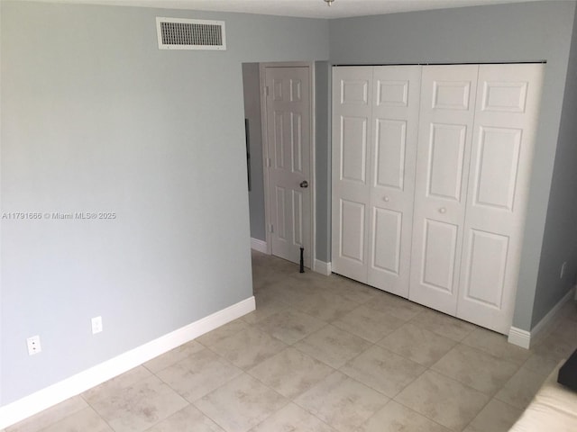 1990 NW 4th Ct Unit 8, Miami, FL 33136 - unfurnished bedroom featuring light tile patterned floors, a closet, visible vents, and baseboards