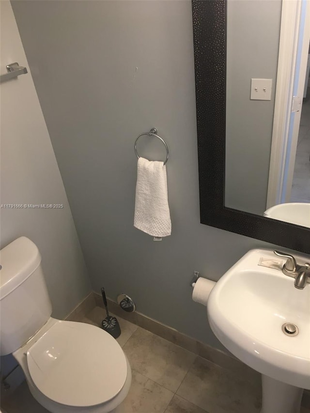 1990 NW 4th Ct Unit 8, Miami, FL 33136 - half bathroom with baseboards, toilet, and a sink