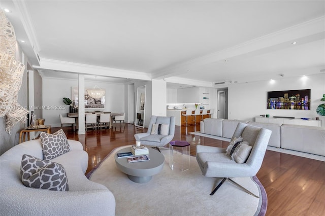 living area featuring ornamental molding, recessed lighting, and wood finished floors
