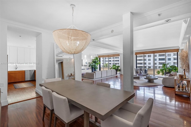dining area with crown molding, a chandelier, and dark wood finished floors