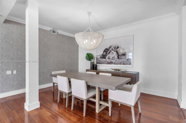 dining space with wood finished floors, crown molding, visible vents, and baseboards