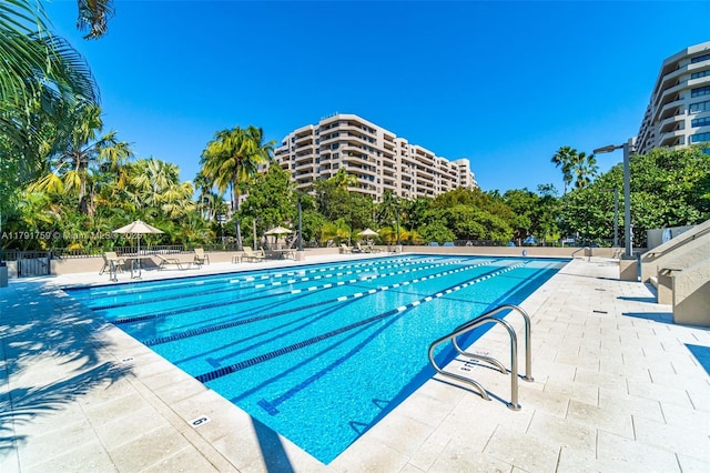 community pool featuring a patio and fence