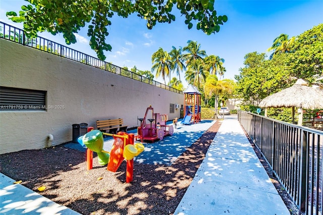 view of home's community with fence, a gazebo, and a playground