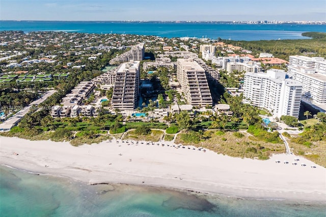 bird's eye view featuring a view of the beach, a city view, and a water view