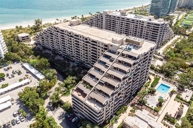 drone / aerial view featuring a beach view, a water view, and a view of city