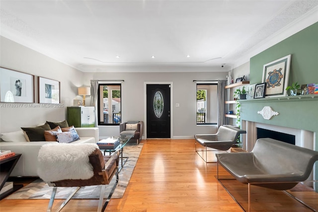 living room with light wood finished floors, recessed lighting, baseboards, and a fireplace