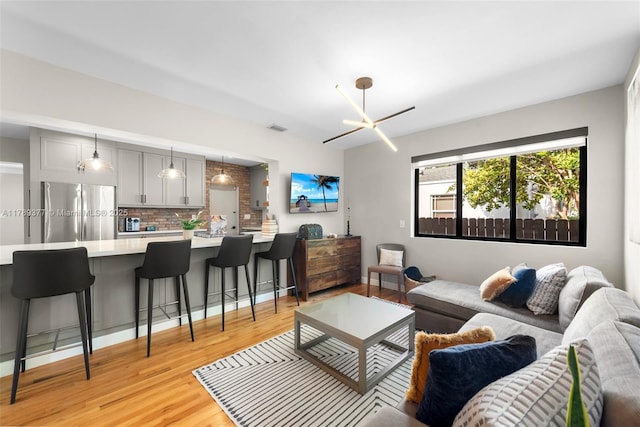 living area featuring visible vents and light wood finished floors