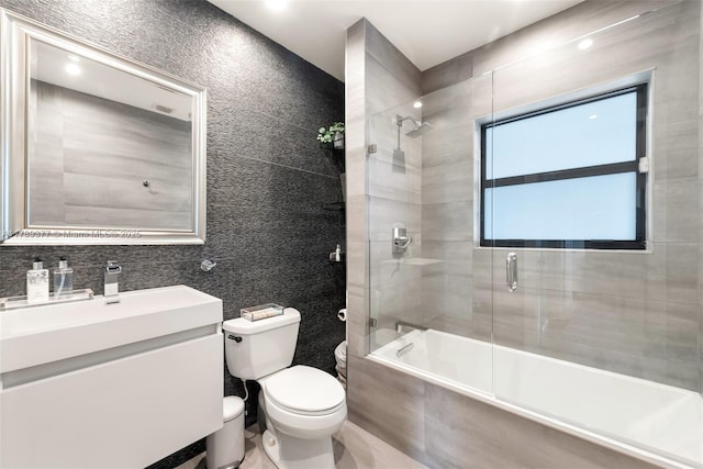 full bath featuring vanity, toilet, and tiled shower / bath combo