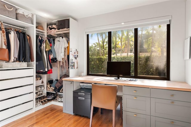 interior space featuring built in study area and light wood-style floors