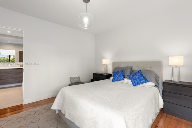 bedroom featuring baseboards and wood finished floors