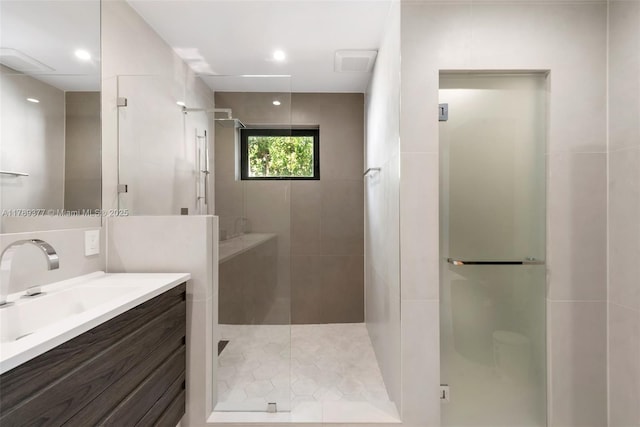 full bathroom with a stall shower and vanity