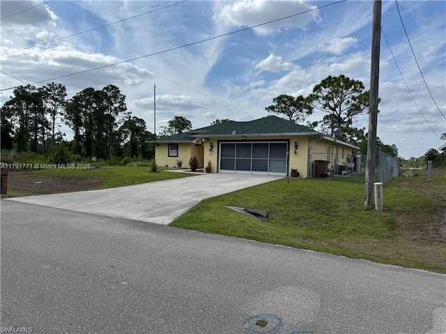 1127 Foggia St E, Lehigh Acres, FL 33974 - ranch-style home with concrete driveway, a front yard, an attached garage, and stucco siding
