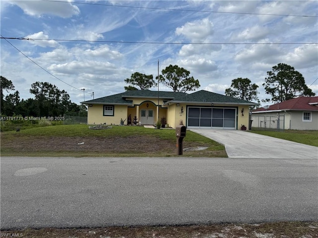 1127 Foggia St E, Lehigh Acres, FL 33974 - view of front of house with stucco siding, concrete driveway, and a garage