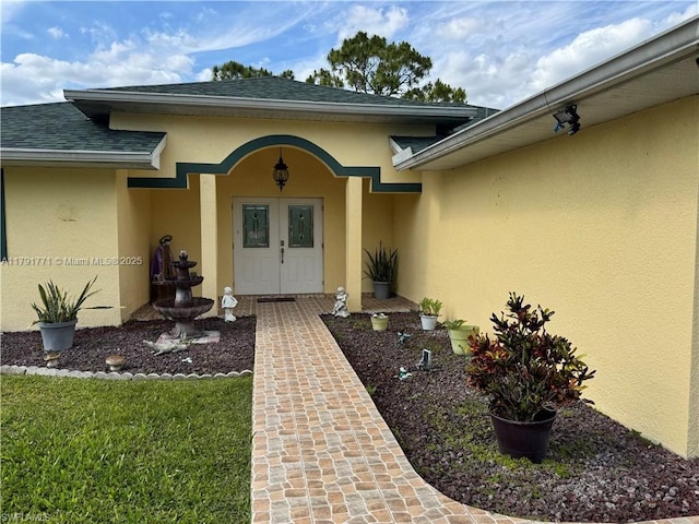 1127 Foggia St E, Lehigh Acres, FL 33974 - entrance to property with stucco siding and roof with shingles