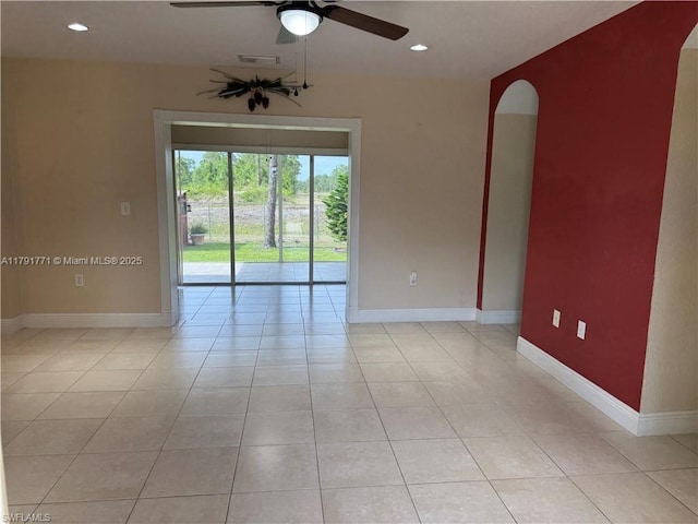 1127 Foggia St E, Lehigh Acres, FL 33974 - spare room with light tile patterned floors, ceiling fan, and baseboards