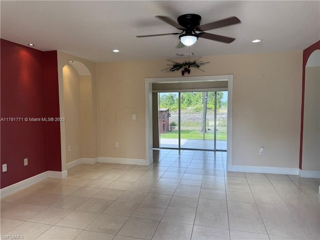 1127 Foggia St E, Lehigh Acres, FL 33974 - empty room featuring recessed lighting, arched walkways, light tile patterned floors, ceiling fan, and baseboards