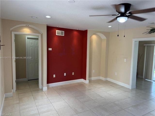 1127 Foggia St E, Lehigh Acres, FL 33974 - unfurnished room featuring light tile patterned floors, visible vents, arched walkways, recessed lighting, and a ceiling fan