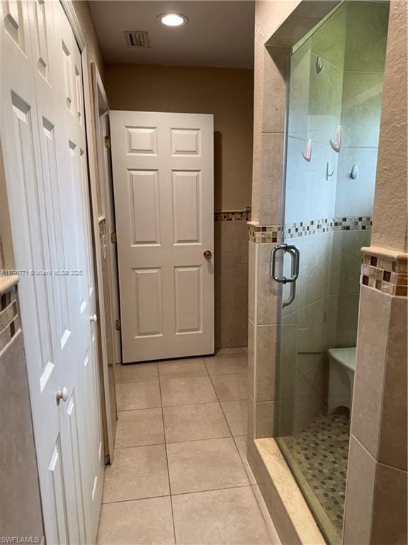 1127 Foggia St E, Lehigh Acres, FL 33974 - bathroom featuring visible vents, a stall shower, recessed lighting, tile walls, and tile patterned flooring
