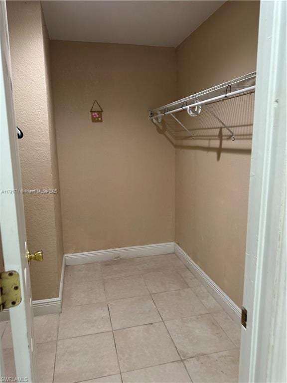 1127 Foggia St E, Lehigh Acres, FL 33974 - spacious closet with light tile patterned flooring