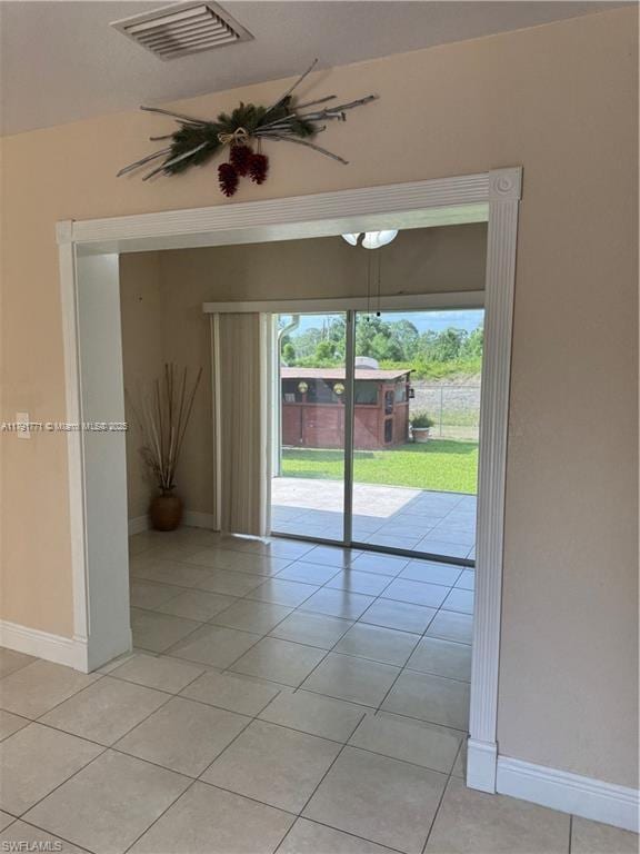 1127 Foggia St E, Lehigh Acres, FL 33974 - empty room featuring light tile patterned floors, visible vents, and baseboards