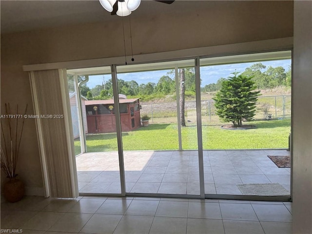 1127 Foggia St E, Lehigh Acres, FL 33974 - doorway to outside with tile patterned floors and a ceiling fan