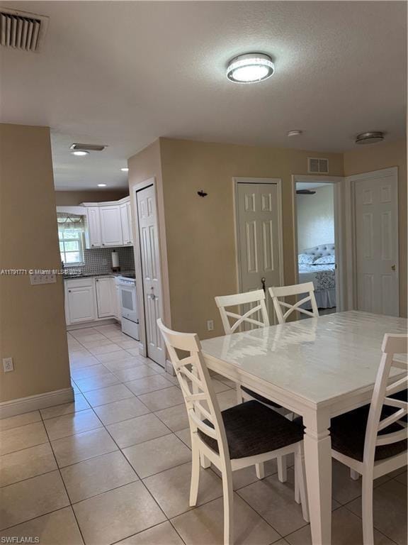 1127 Foggia St E, Lehigh Acres, FL 33974 - dining room featuring light tile patterned flooring, visible vents, and baseboards