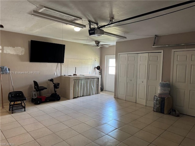 1127 Foggia St E, Lehigh Acres, FL 33974 - garage with ceiling fan and a garage door opener