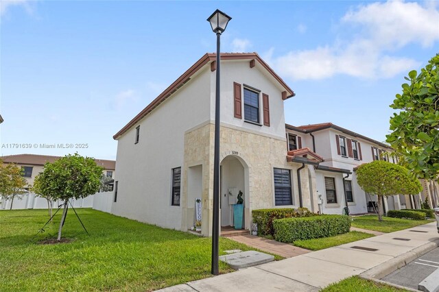 3289 W 106th Ter, Hialeah, FL 33018 - mediterranean / spanish-style house with stucco siding, fence, and a front lawn