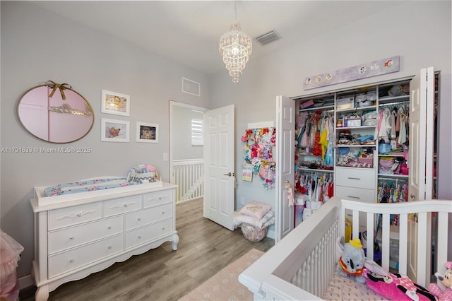 3289 W 106th Ter, Hialeah, FL 33018 - bedroom with a chandelier, visible vents, wood finished floors, and a closet